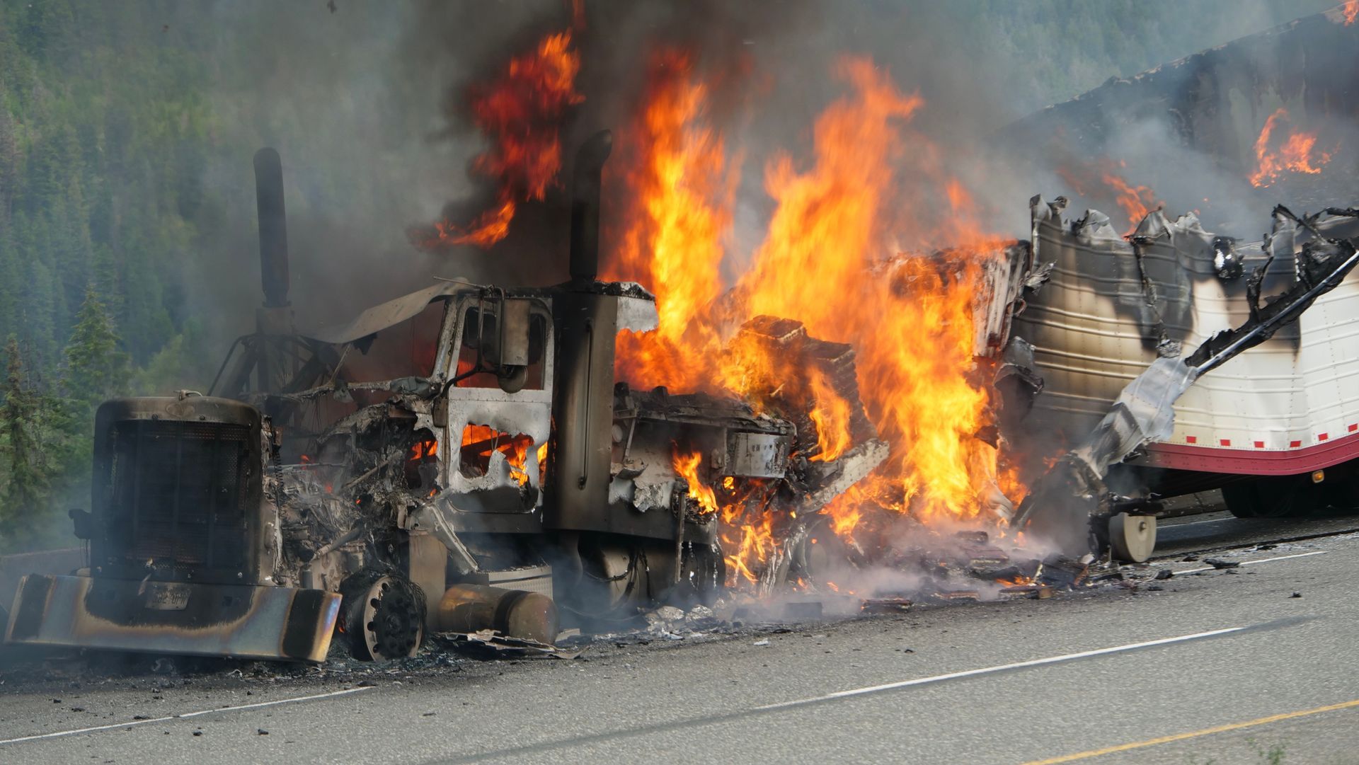 Damaged commercial truck at a highway collision scene